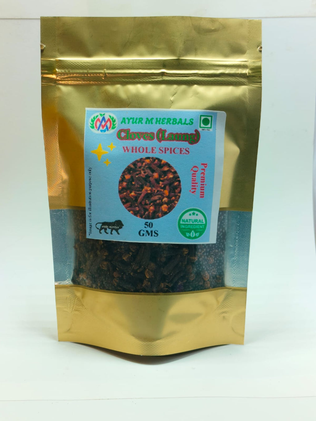 A stand-up resealable pouch of Ayur M Herbals Clive (Lunge) Whole Spices, showing dark whole spices inside through a clear window on a white background.
