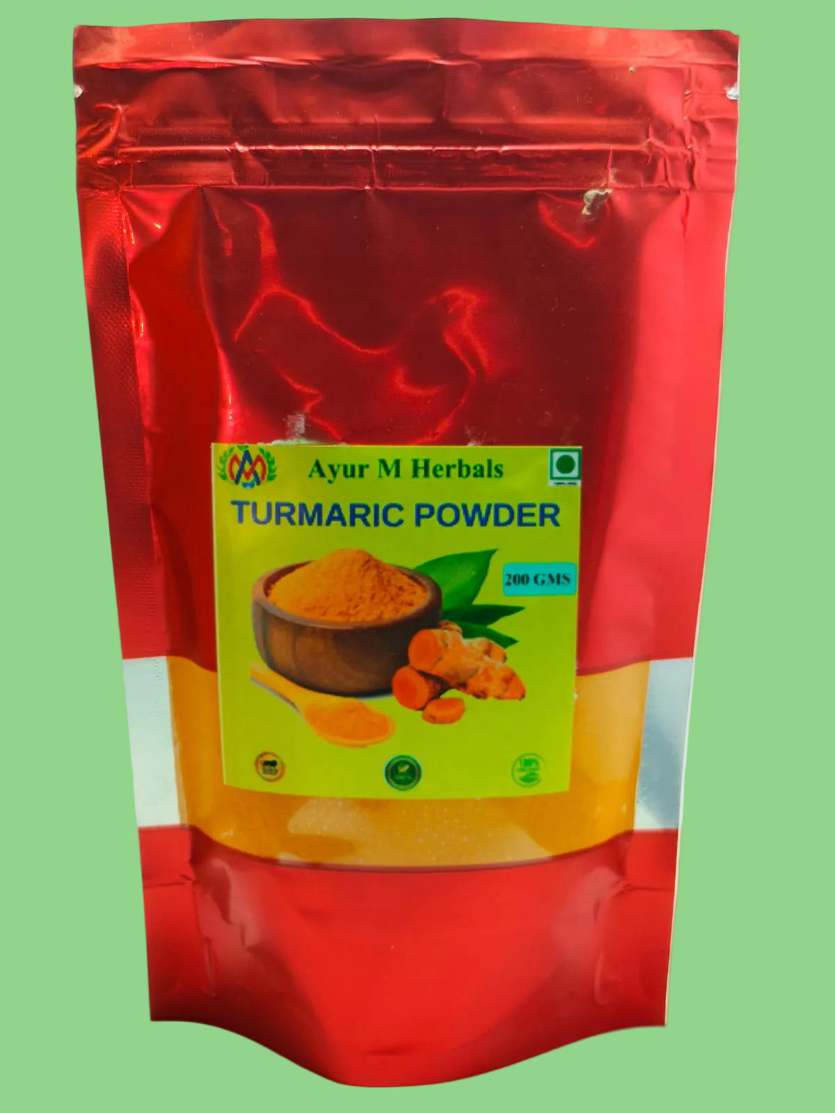 A red stand-up pouch of Ayur M Herbals Turmeric Powder-200gms, featuring a green and yellow label with an illustration of turmeric roots and a bowl of powder.