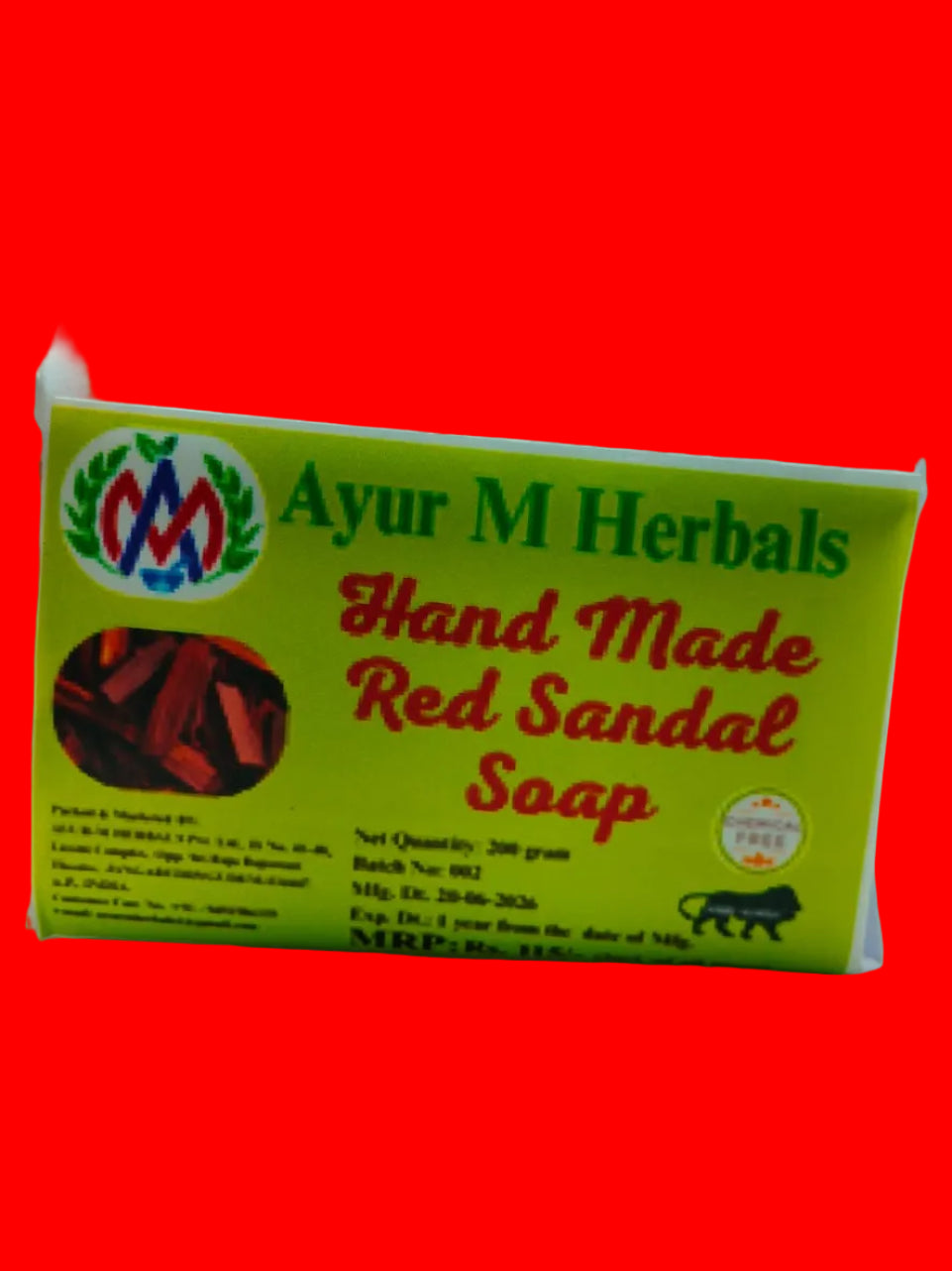 A rectangular box of Ayur M Herbals Hand Made Red Sandal Soap, featuring a bright yellow-green label with red and green text, photographed on a plain off-white background.